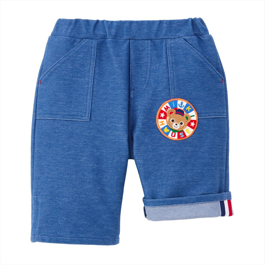 Blue three-quarter-length pants with an elastic waist and bear patch.